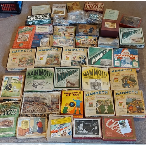 380 - A Mammoth Jigsaw Puzzle together with a collection of other puzzles