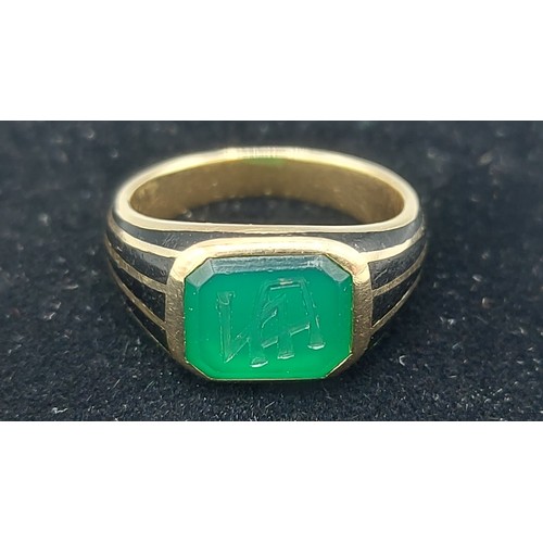 134 - A Continental Gold and enamel ring set with intaglio stone, ring size P, 7.9g
