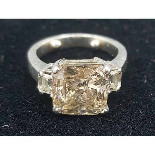 155 - A Solitaire Diamond ring set with  Princess cut Diamond, approx. 5.20ct flanked by Baguette cut Diam... 