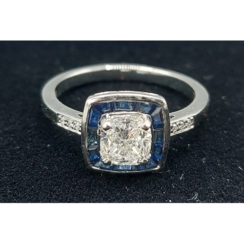 166 - A Platinum Diamond and Sapphire ring set with a central cushion cut Diamond, 1.01ct surrounded by Sa... 