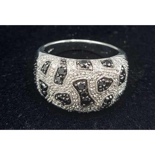 173 - A 9ct white gold Diamond set cluster ring with white and black Diamonds, 7.6gms, ring size N