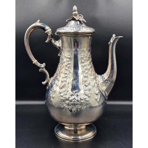 A Victorian silver coffee pot with embossed decoration and shaped ...