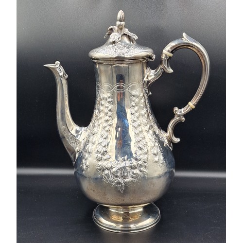 A Victorian silver coffee pot with embossed decoration and shaped ...