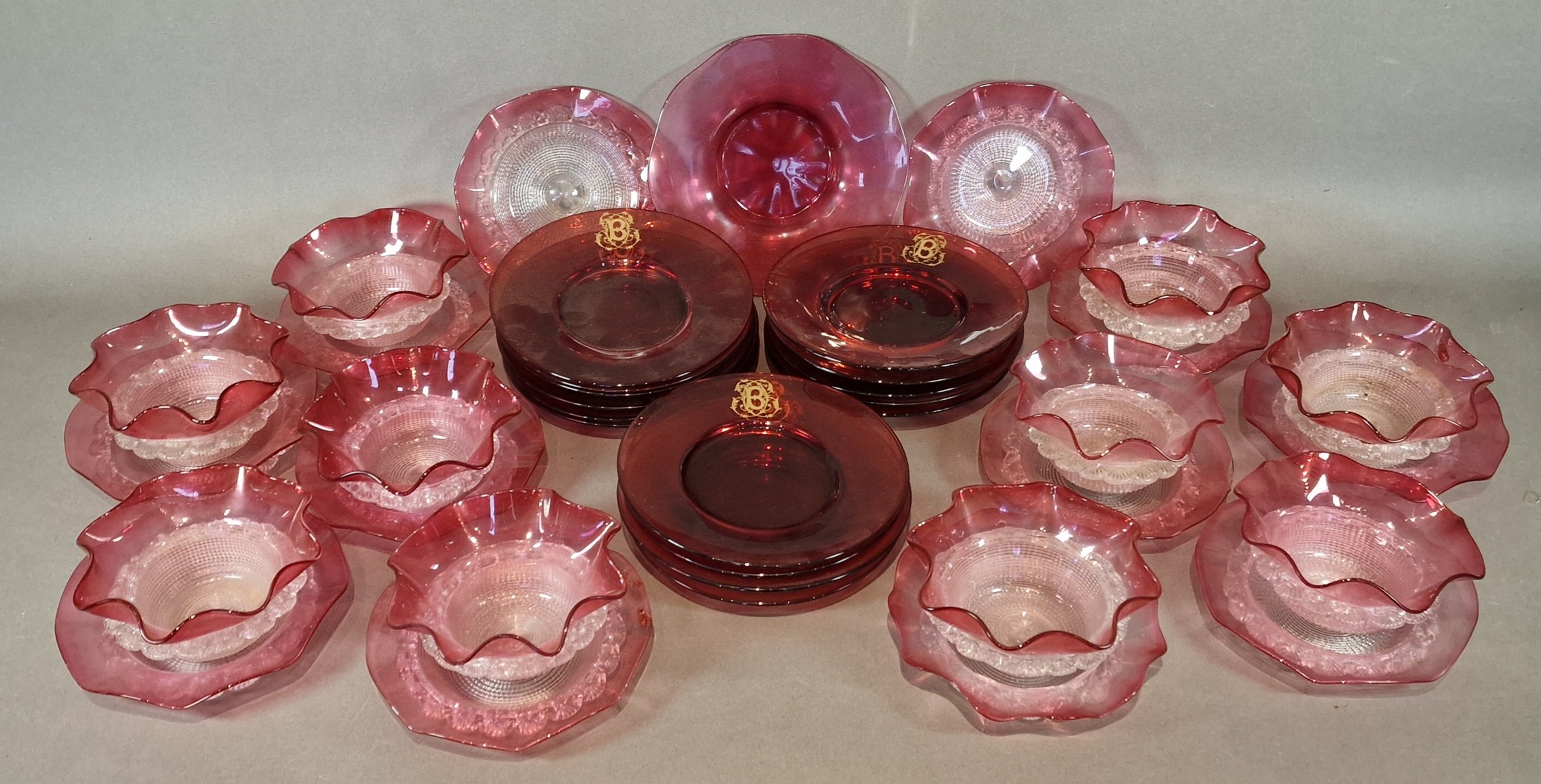 A set of fifteen Cranberry glass plates, each with a gilded 'B ...