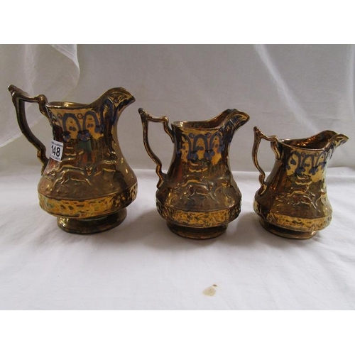 148 - 3 graduated gilt jugs