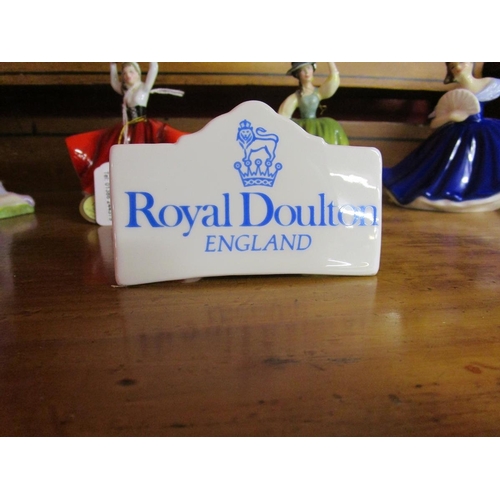 284 - Collection of five Royal Doulton figurines and ceramic sign