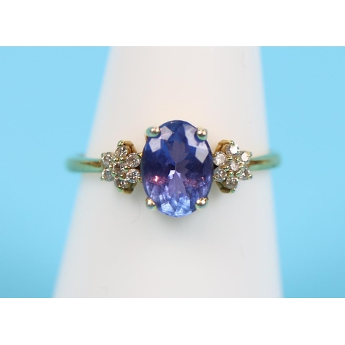 66 - 14 carat gold diamond and tanzanite ring