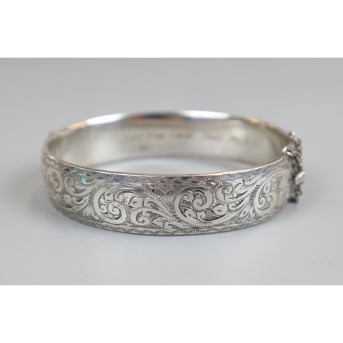 68 - Hallmarked silver bangle along with another marked '9ct metal core'