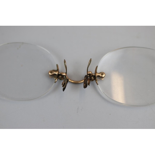 22 - Pair of pinch spectacles, possibly gold mounted