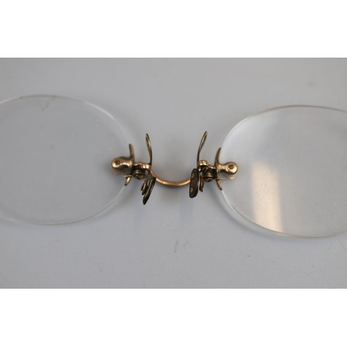 22 - Pair of pinch spectacles, possibly gold mounted