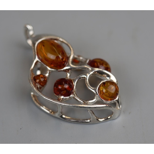 31 - Unusual silver & amber pendant