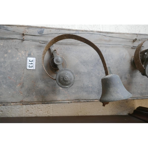 313 - 7 antique servants bells mounted on wood