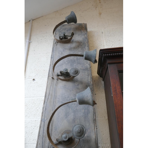 313 - 7 antique servants bells mounted on wood