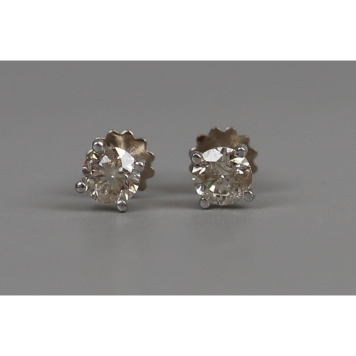 36 - Pair of 18ct white gold ½ct diamond stud earrings