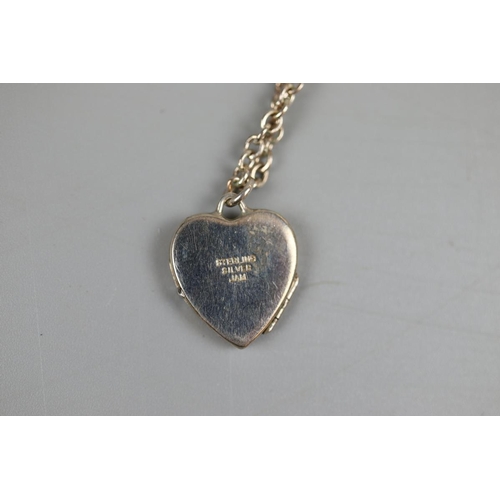 49 - Silver locket on chain & silver ring