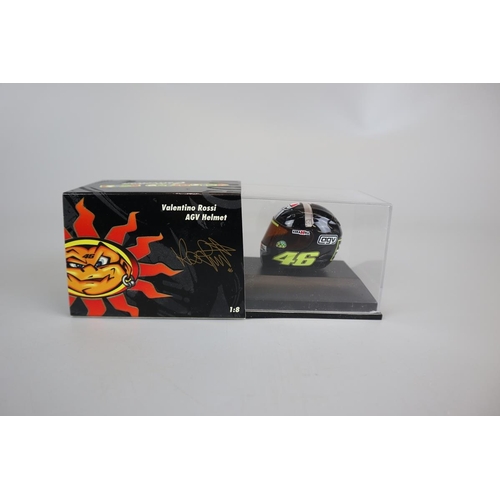 152 - Collection of 9 Minichamps 1:8 scale model AVG Valentino Rossi helmets