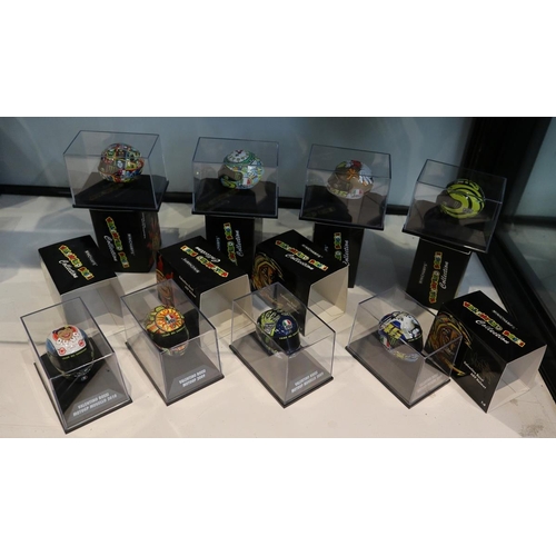 154 - Collection of 8 Minichamps 1:8 scale model AVG Valentino Rossi helmets