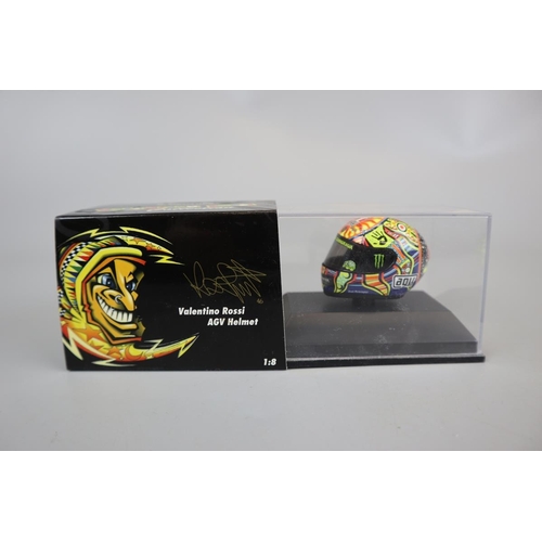 154 - Collection of 8 Minichamps 1:8 scale model AVG Valentino Rossi helmets