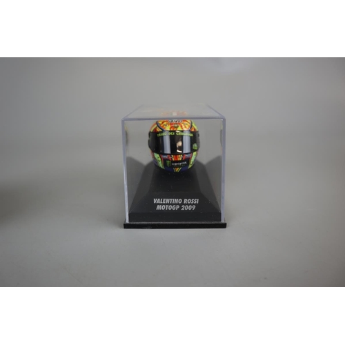 154 - Collection of 8 Minichamps 1:8 scale model AVG Valentino Rossi helmets