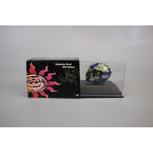 154 - Collection of 8 Minichamps 1:8 scale model AVG Valentino Rossi helmets