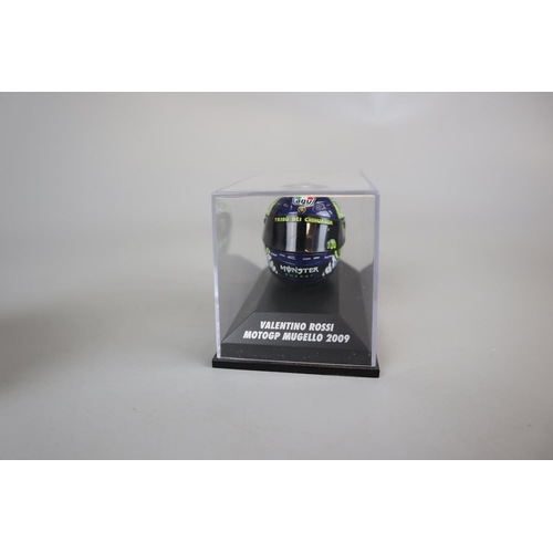 154 - Collection of 8 Minichamps 1:8 scale model AVG Valentino Rossi helmets