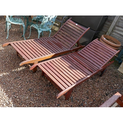 533 - Pair of teak steamer recliners with cushions