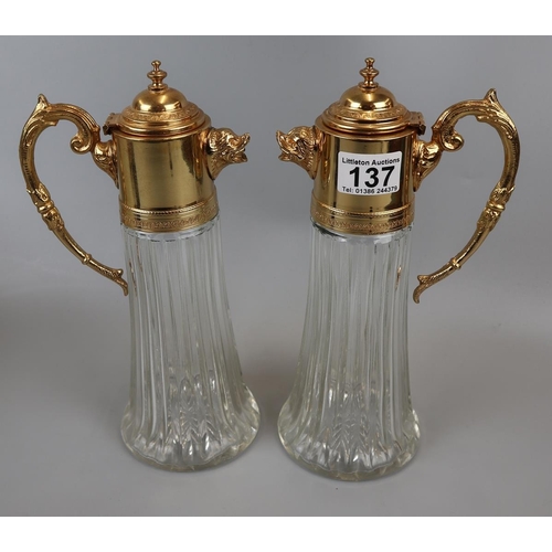 137 - Pair of gilt metal & glass claret jugs