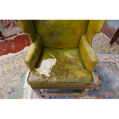 245 - Green leather wing back armchair