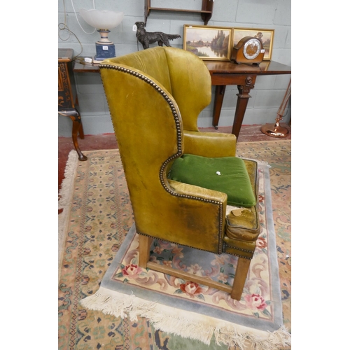 245 - Green leather wing back armchair