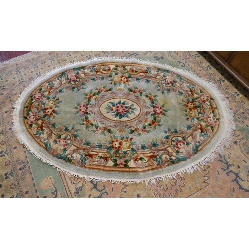 247 - Oval Chinese green patterned rug