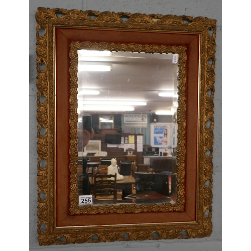 255 - Antique bevelled glass mirror in ornate gilt frame