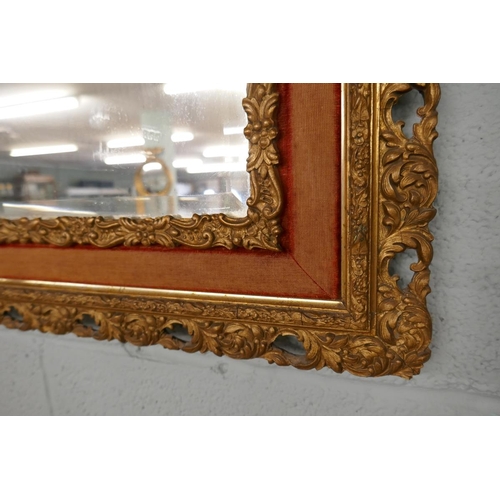 255 - Antique bevelled glass mirror in ornate gilt frame