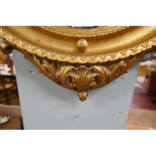 283 - Gilt framed convex mirror adorned with eagle