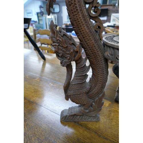 297 - Ornately carved Chinese tripod table