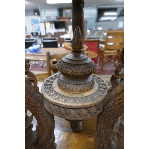 297 - Ornately carved Chinese tripod table