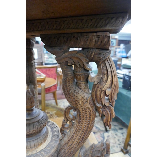 297 - Ornately carved Chinese tripod table