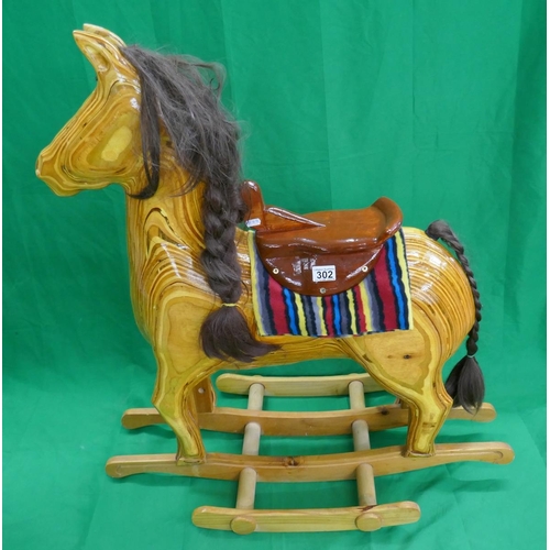 302 - Carved hardwood rocking horse