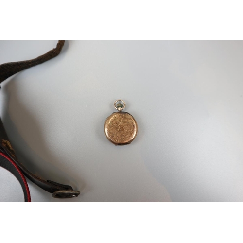 74 - Gold pocket watch in wrist strap