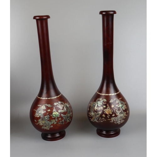 69 - Pair of rosewood vases inlaid with mother of pearl depicting dragons - Approx. H: 40cm