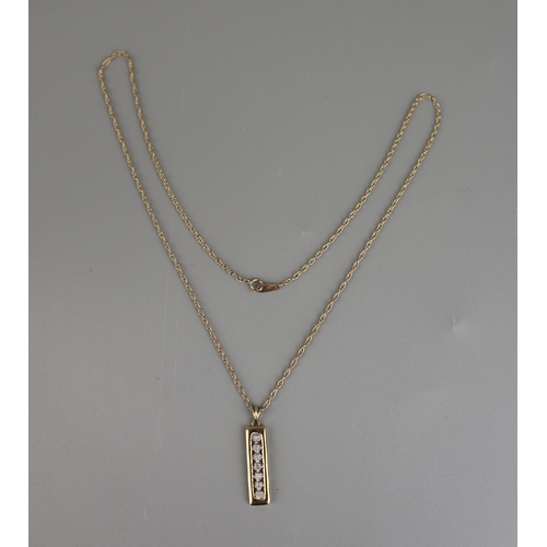 147 - Gold 7 stone diamond pendant on a gold rope chain