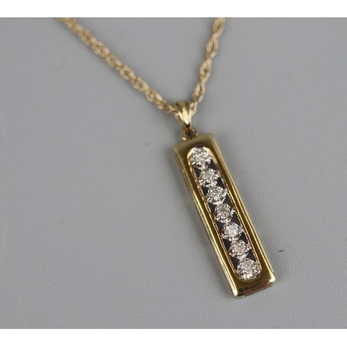 147 - Gold 7 stone diamond pendant on a gold rope chain