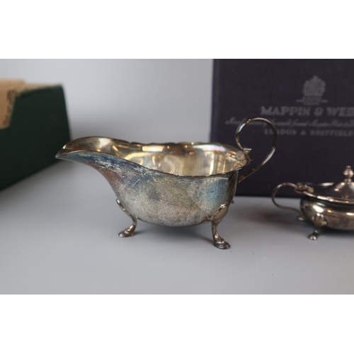 21 - Collection of Mappin & Webb to include a hallmarked silver sauce boat - Approx weight of saucebo... 