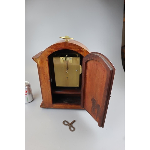 138 - Inlaid mantel clock on brass claw feet