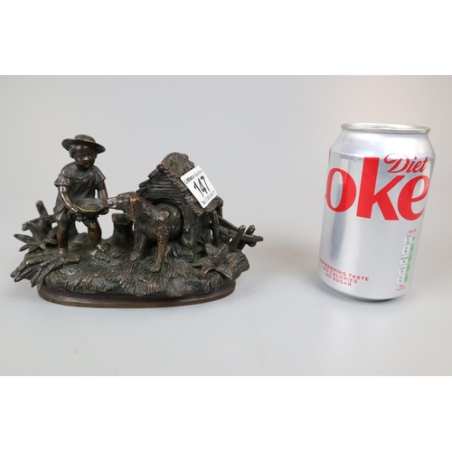 147 - 19thC bronze ink well and pen holder in the form of a child feeding a dog