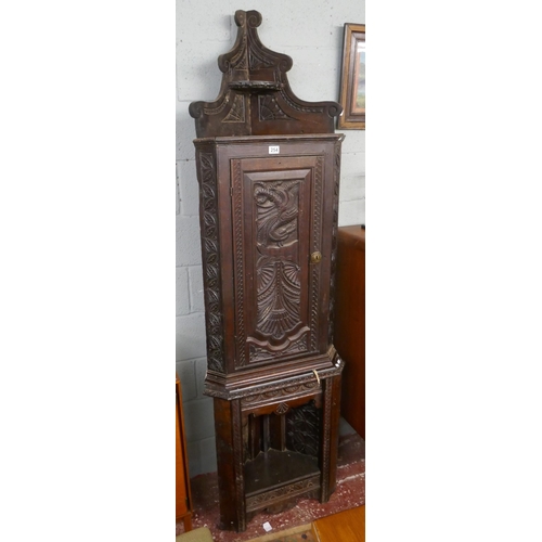 254 - Tall antique carved oak corner cupboard