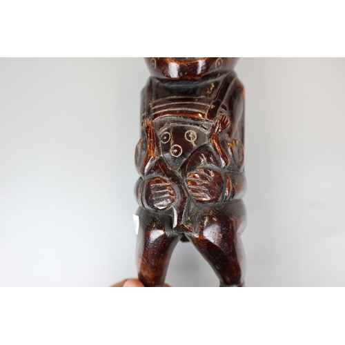 94 - Unusual heavy carved African figure - Approx. height 23cm