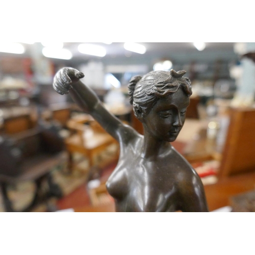 344 - Bronze nude with bow on marble base - Approx. height 33cm