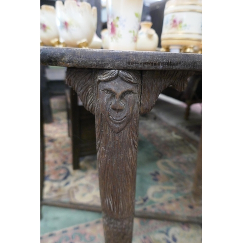 371 - Carved oak occasional table with merman themed legs