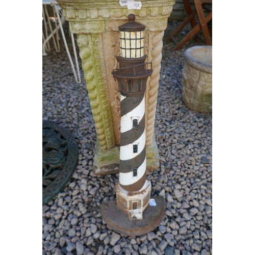 459 - Cast iron lighthouse and stone garden plinth