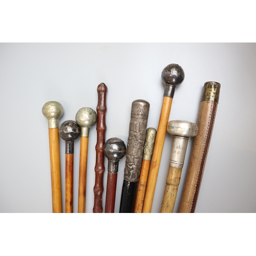 122 - Collection of 11 swagger sticks to include silver mounted examples